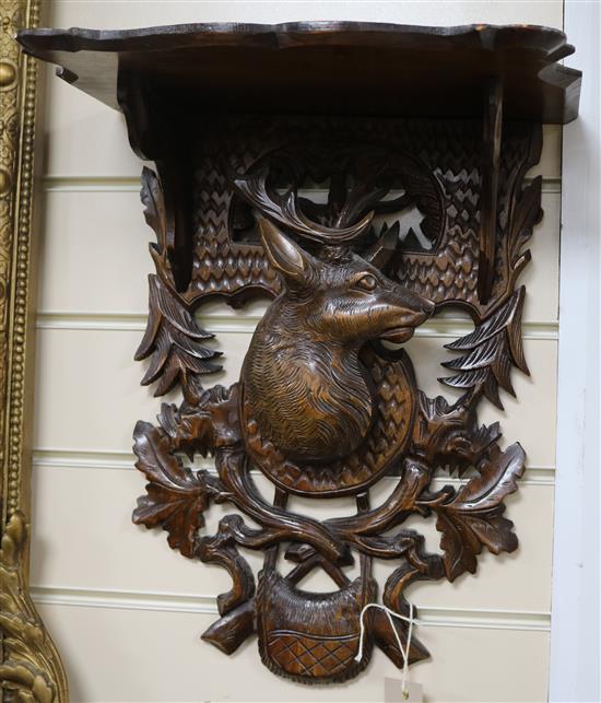 Two Black Forest carved wood wall shelves, H.38cm